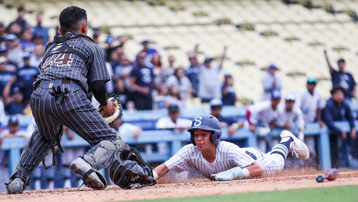 Sylmar's Emilio Ochoa is tagged out by catcher Sebastian Castellano trying to score from second 