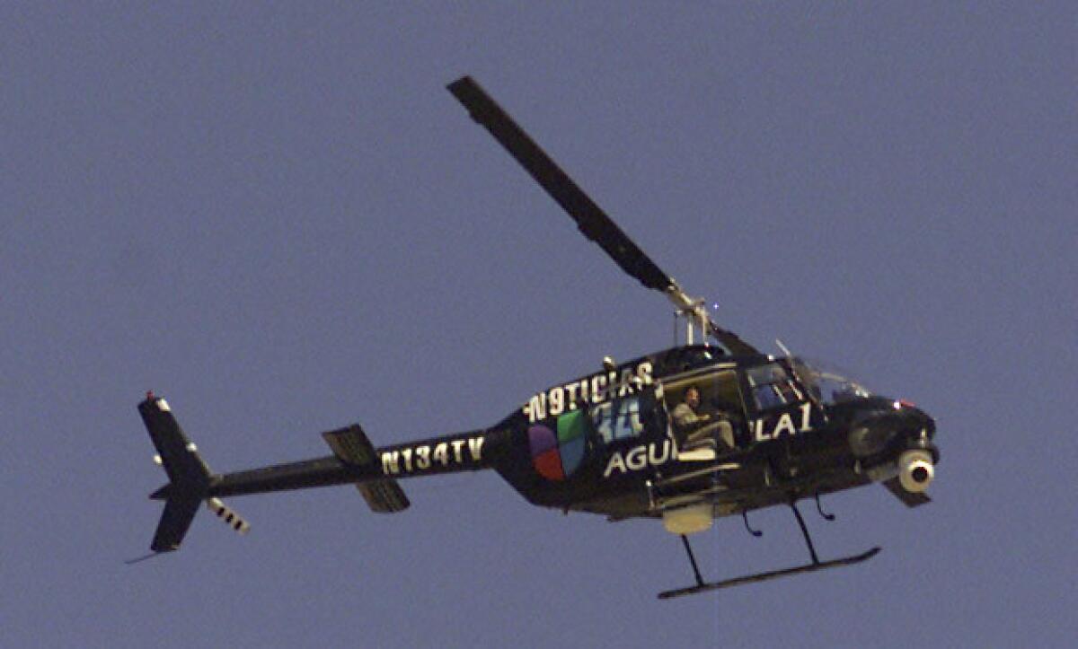 A news helicopter flies above Canoga Park. Media flights such has this one would be affected by proposed flight rules to reduce noise over residential and commercial areas.