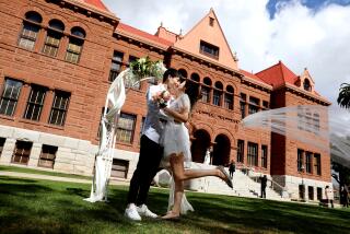 SANTA ANA, CA - FEBRUARY 22: Lu Zheng (cq), 34, left, of Ontario, and Laura Li, 30, along with other couples, tie the knot on unforgettable 2/22/22 wedding date at the Old County Courthouse in downtown on Tuesday, Feb. 22, 2022 in Santa Ana, CA. The couple said is was a specail day for them, alot of number twos. For those looking for marriage bliss on a once-in-a-lifetime and easy to remember marriage anniversary date, your day is just around the corner. This upcoming Twos Day, which is Tuesday, February 22, 2022 (2-22-22), Orange County Clerk-Recorder Hugh Nguyen will be offering extended hours at his offices in Anaheim, Laguna Hills and at the Old Orange County Courthouse in Santa Ana. (Gary Coronado / Los Angeles Times)
