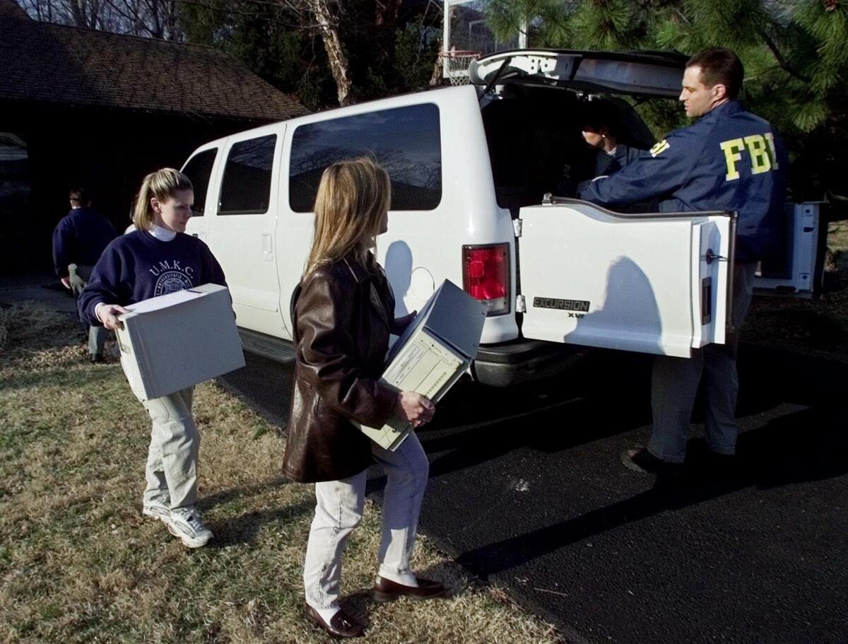 FBI agents load computers taken from the home of FBI agent Robert Philip Hanssen into an agency vehicle in Vienna, Va., on Feb. 20, 2001.