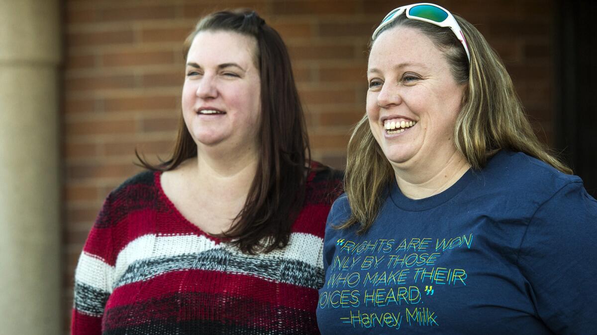April Hoagland, left, and Beckie Peirce after a judge reversed his ruling to take away their 9-month-old child last week.