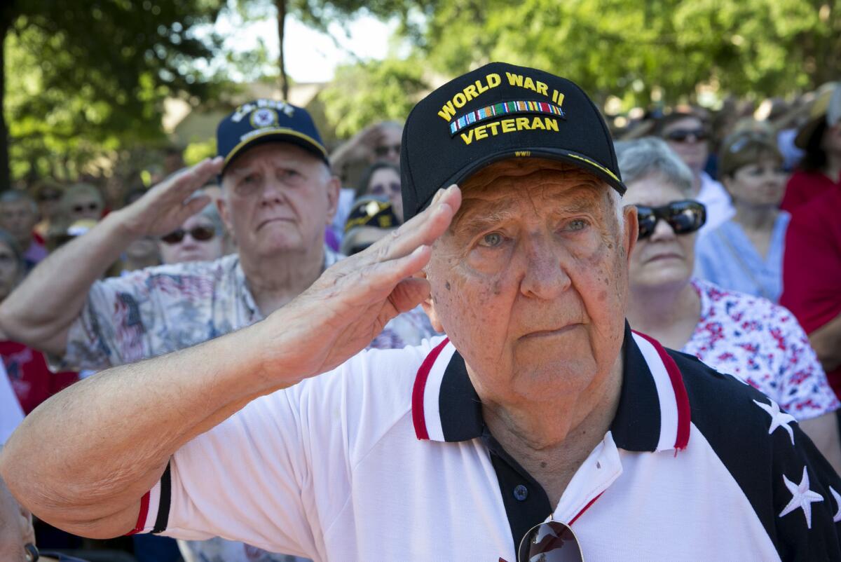 Navy Korean War veteran Bob Shaw, left, and Navy World War II veteran Howard Konetchy salute during the national anthem at a Memorial Day observance at the Georgetown-Williamson County Veterans Memorial Plaza in Sun City, Texas.