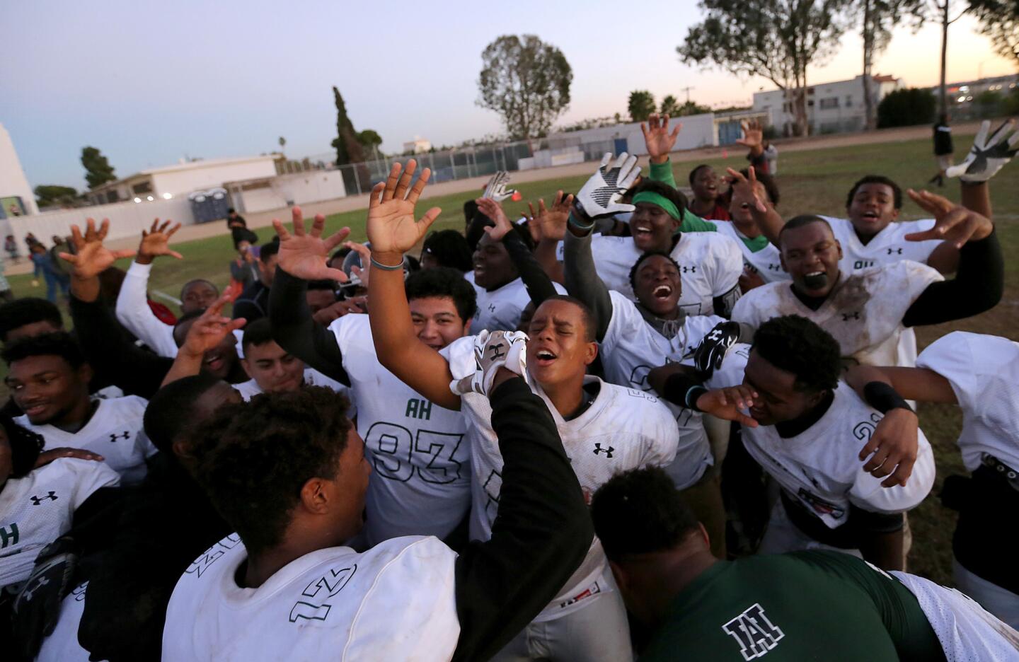 Hawkins High players celebrate after coming from behind to secure a 31-31 tie at Los Angeles High on Friday.