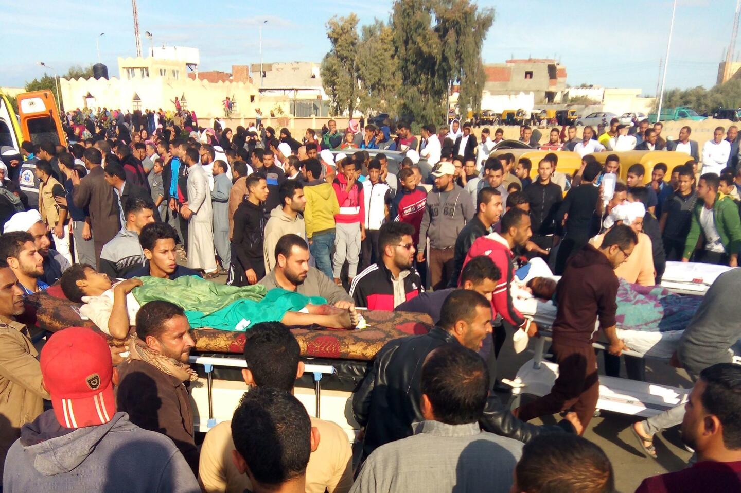 Egyptians carry victims on stretchers after an attack on the Rawda mosque near the North Sinai provincial capital of Arish.