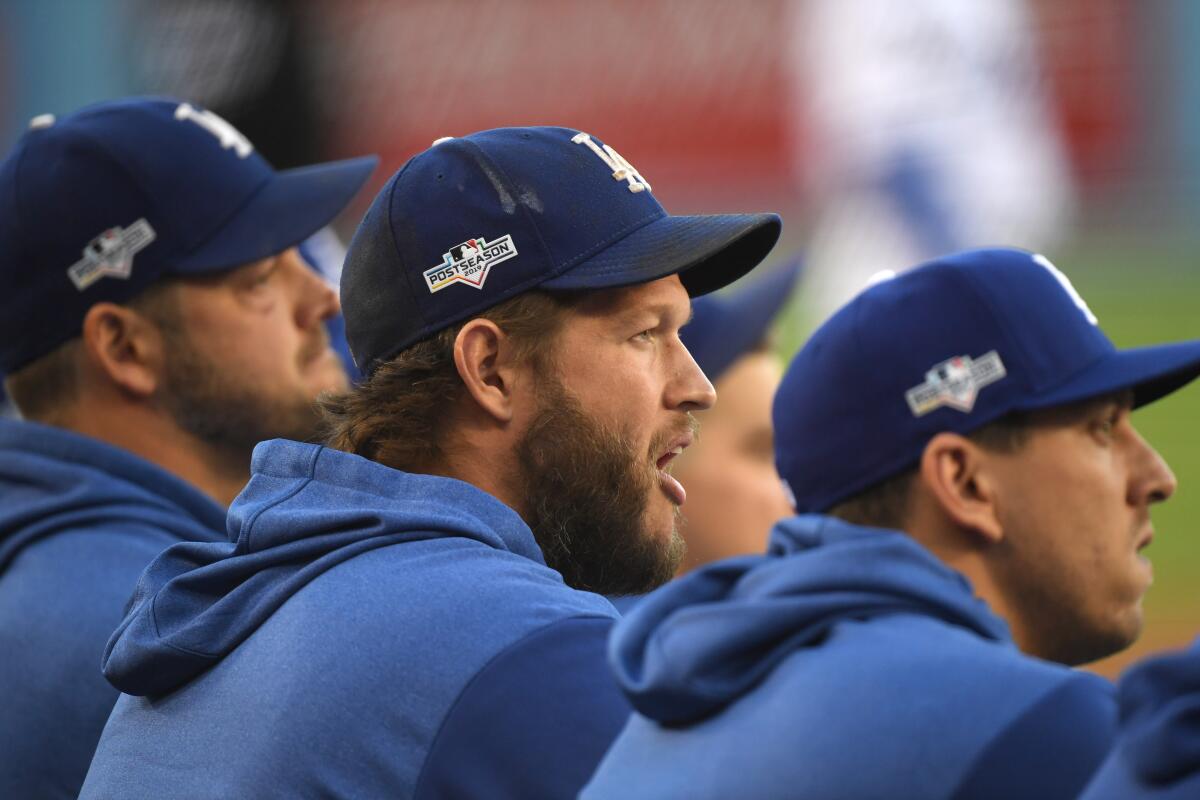 Dodgers pitcher Clayton Kershaw watches from the dugout during Game 1 of the National League Division Series on Thursday.