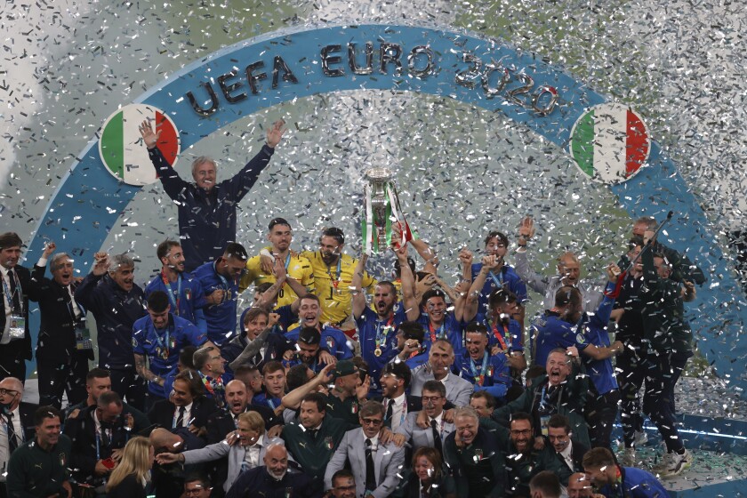 Italian team celebrates with the trophy after the Euro 2020 soccer final match between England and Italy at Wembley stadium in London, Sunday, July 11, 2021. (Catherine Ivill/Pool via AP)
