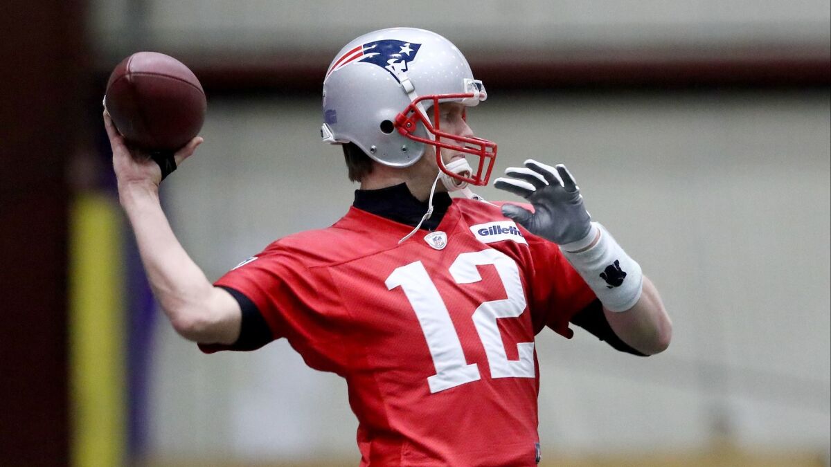 Tom Brady warms up during practice Friday.