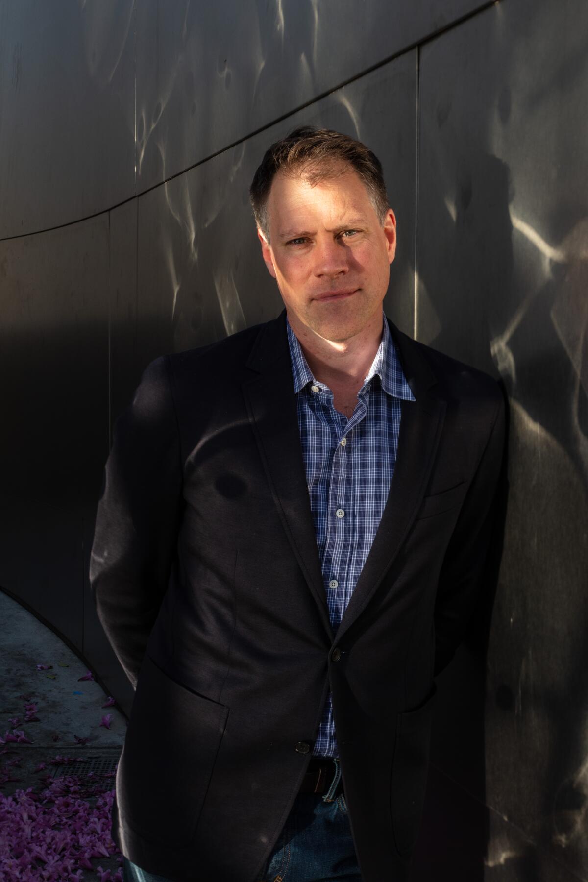 Chad Smith stands against the silver walls of Walt Disney Concert Hall in Los Angeles.