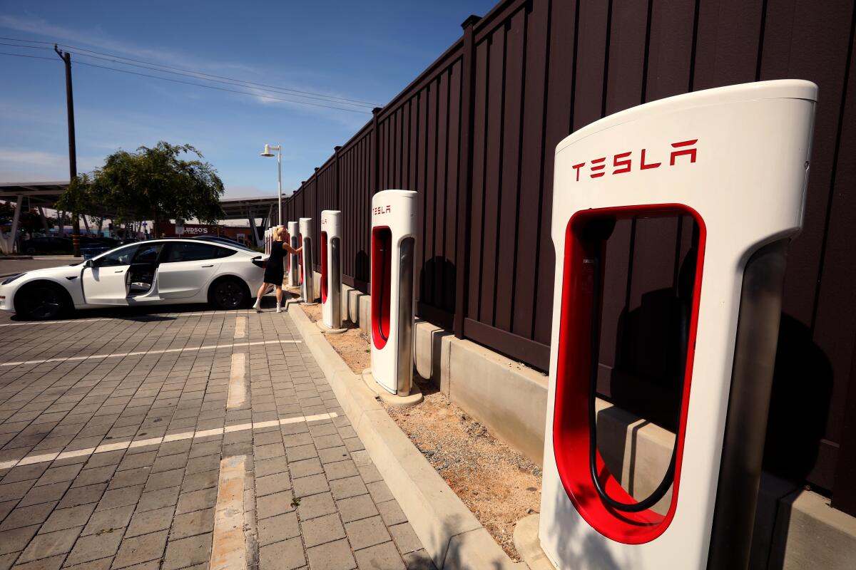 A row of Tesla electric vehicle chargers.