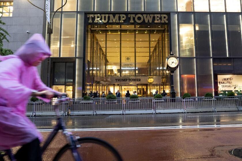 A cyclist moves along a partially opened 5th Avenue after police investigation of a "suspicious item" inside Trump Tower ended Friday, July 27, 2018, in New York. Police say suspicious items have been determined to be harmless. (AP Photo/Craig Ruttle)