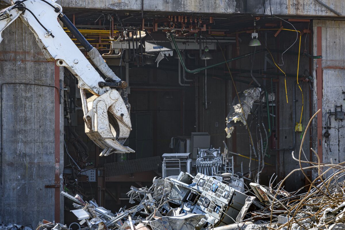 An excavator works on demolishing the Unit 2 Turbine Building at the San Onofre Nuclear Generating Station.