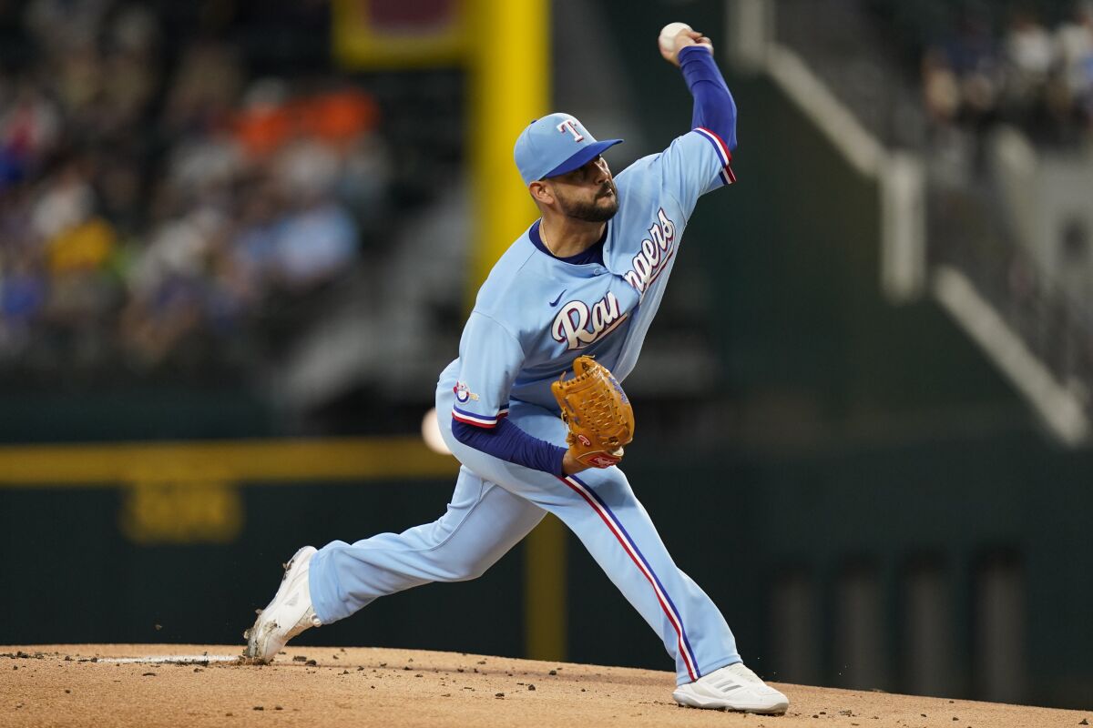Texas Rangers starting pitcher Martin Perez throws during the first inning of a baseball game against the Seattle Mariners in Arlington, Texas, Sunday, June 5, 2022. (AP Photo/LM Otero)