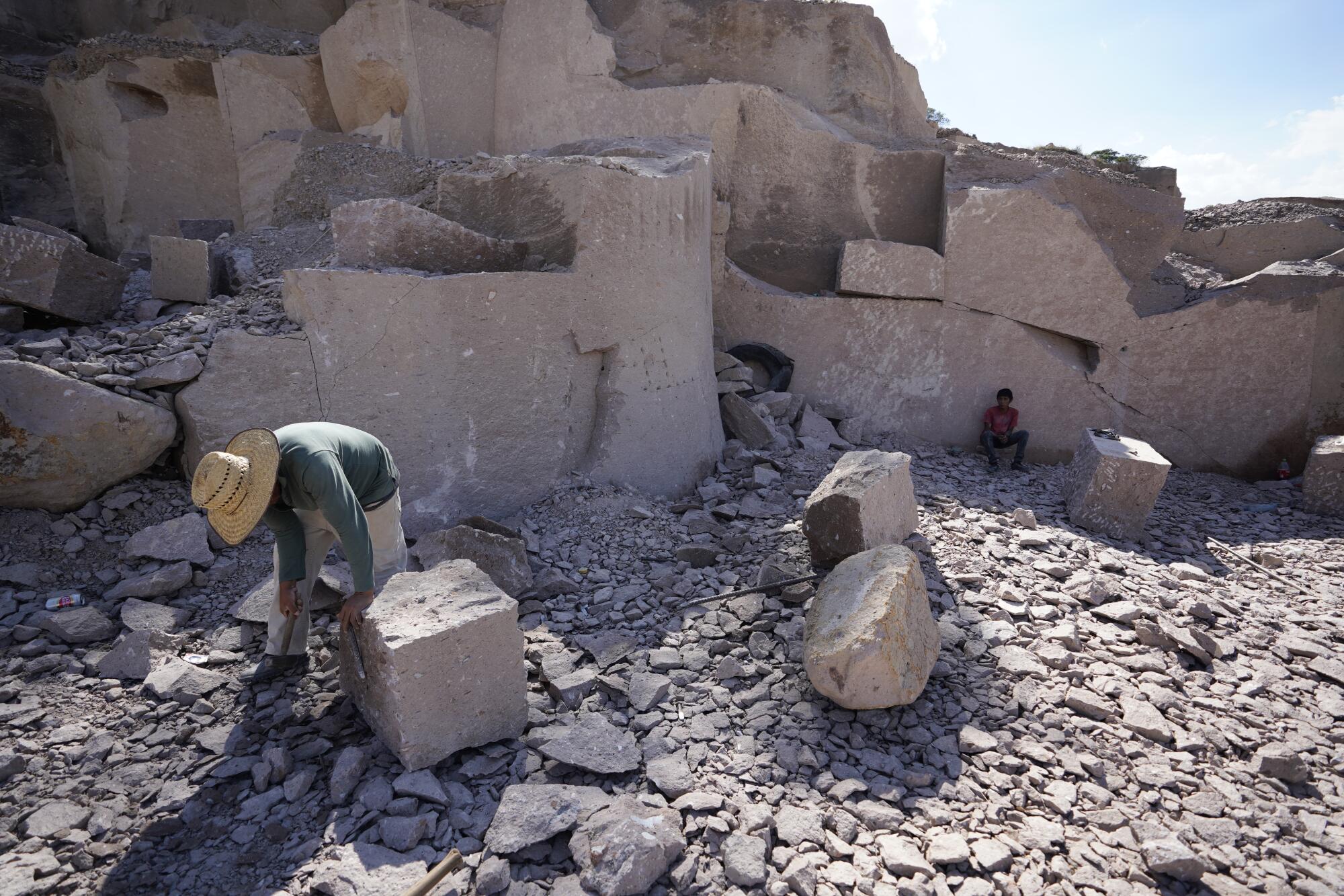 A man works chiseling rocks all day at quarry near the town of El Rincón de San Ildefonso on Thursday.