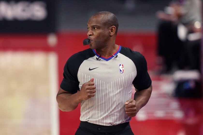 FILE - Referee Tony Brown runs on the sideline during the first half of an NBA basketball game between the Detroit Pistons and the Toronto Raptors, Wednesday, March 17, 2021, in Detroit. NBA referee Tony Brown, who was diagnosed with Stage 4 pancreatic cancer in March, says his treatment is going well and he’s hopeful of possibly returning to the court at some point this season.(AP Photo/Carlos Osorio, File)