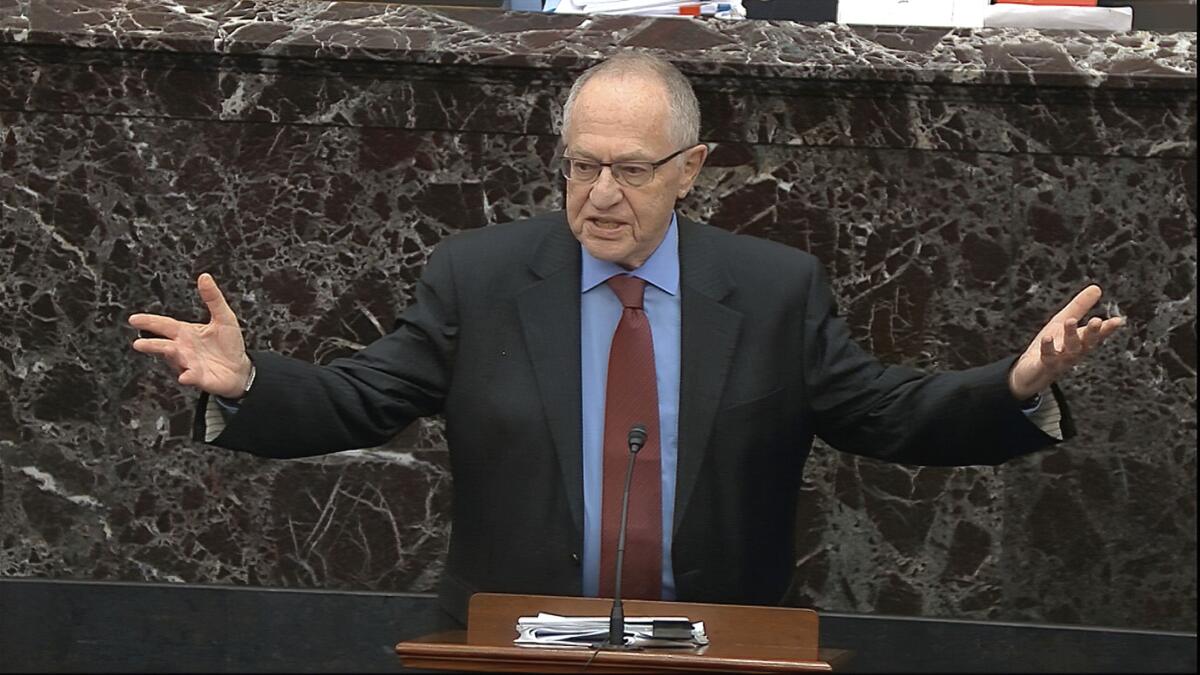 A man in a suit and tie holding his hands out 