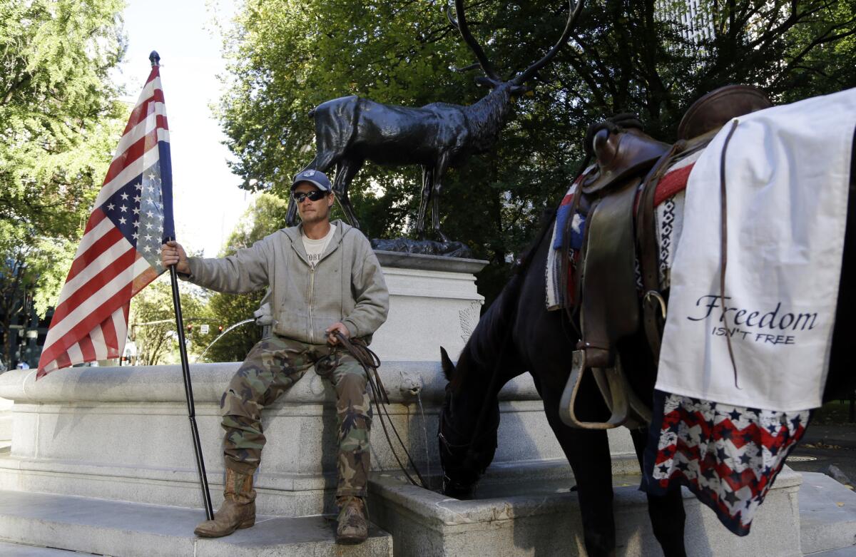 A protester and his horse, Lady Liberty, pause outside the federal courthouse in Portland, Ore., site of the trial of seven anti-government protesters who occupied a federal wildlife refuge this year.