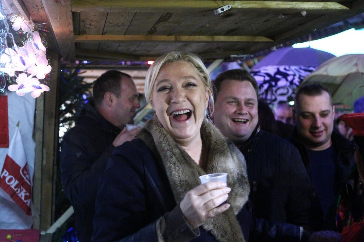 Marine Le Pen, leader of the far-right National Front party, campaigns at the Christmas market in Henin-Beaumont in northern France on Friday.