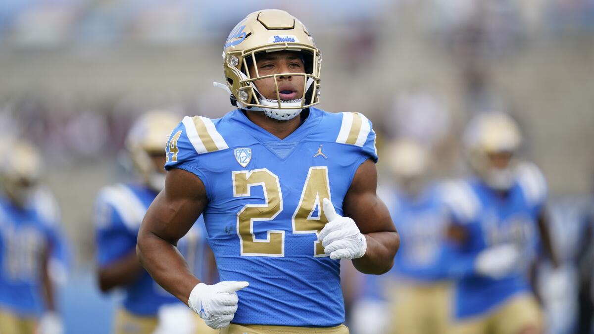 Zach Charbonnet warms up before a UCLA game.