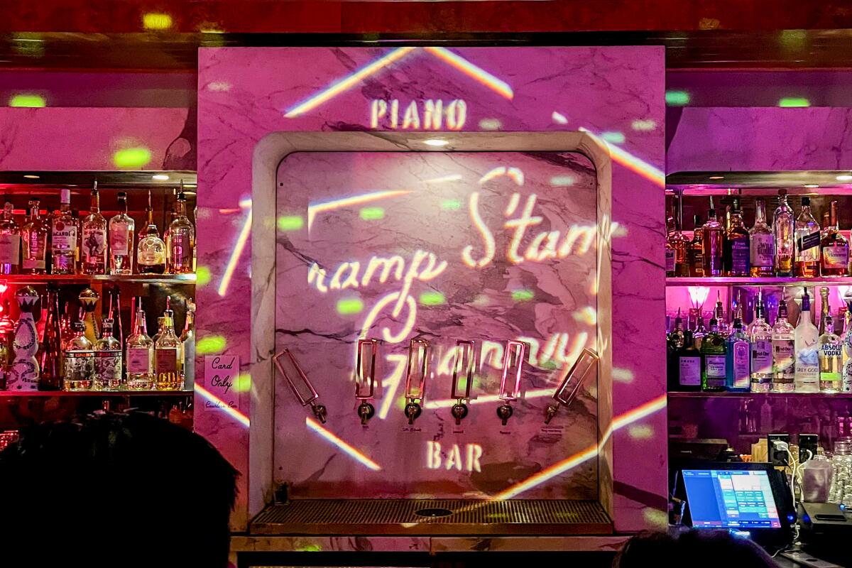 Tramp Stamp Granny's logo is displayed on a bar with liquor bottles on either side.