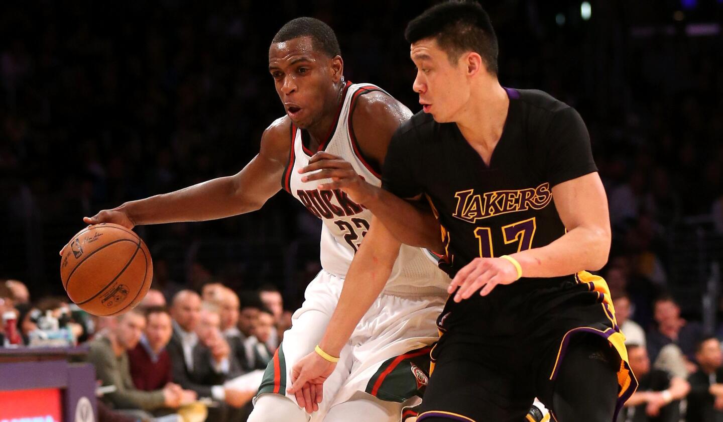 Lakers guard Jeremy Lin tries to cut off a drive by Bucks guard Khris Middleton during their game Friday night.