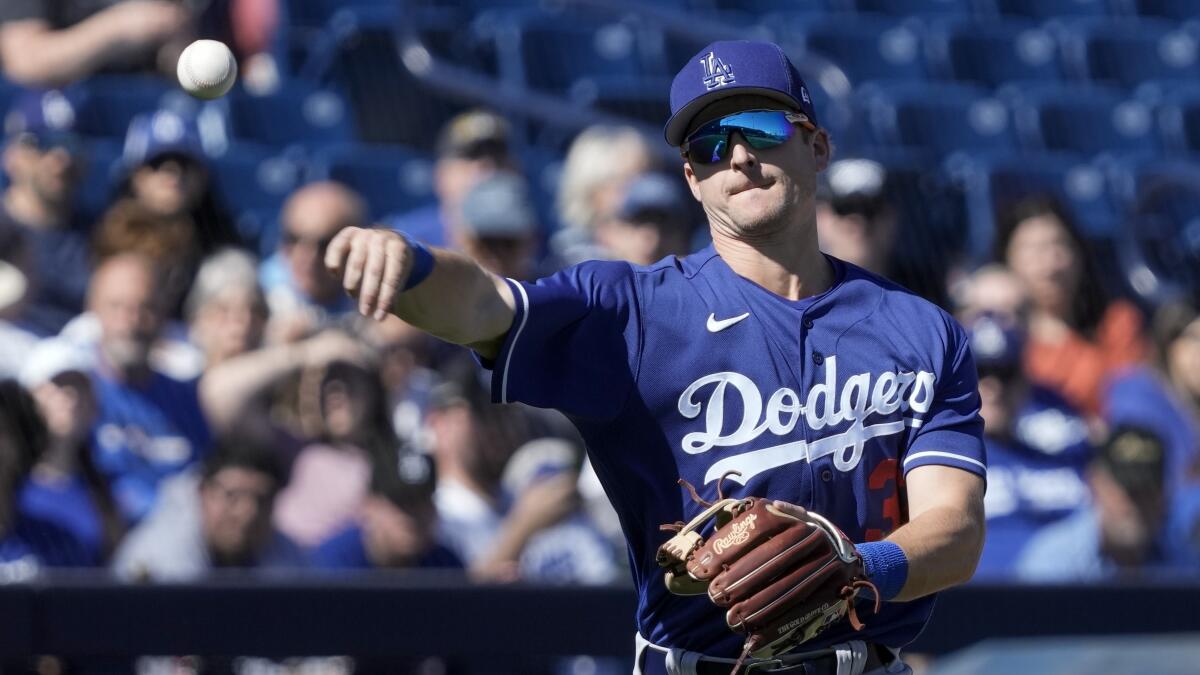Dodgers shortstop Luke Williams throws during a spring-training game against the Milwaukee Brewers on Feb. 25.