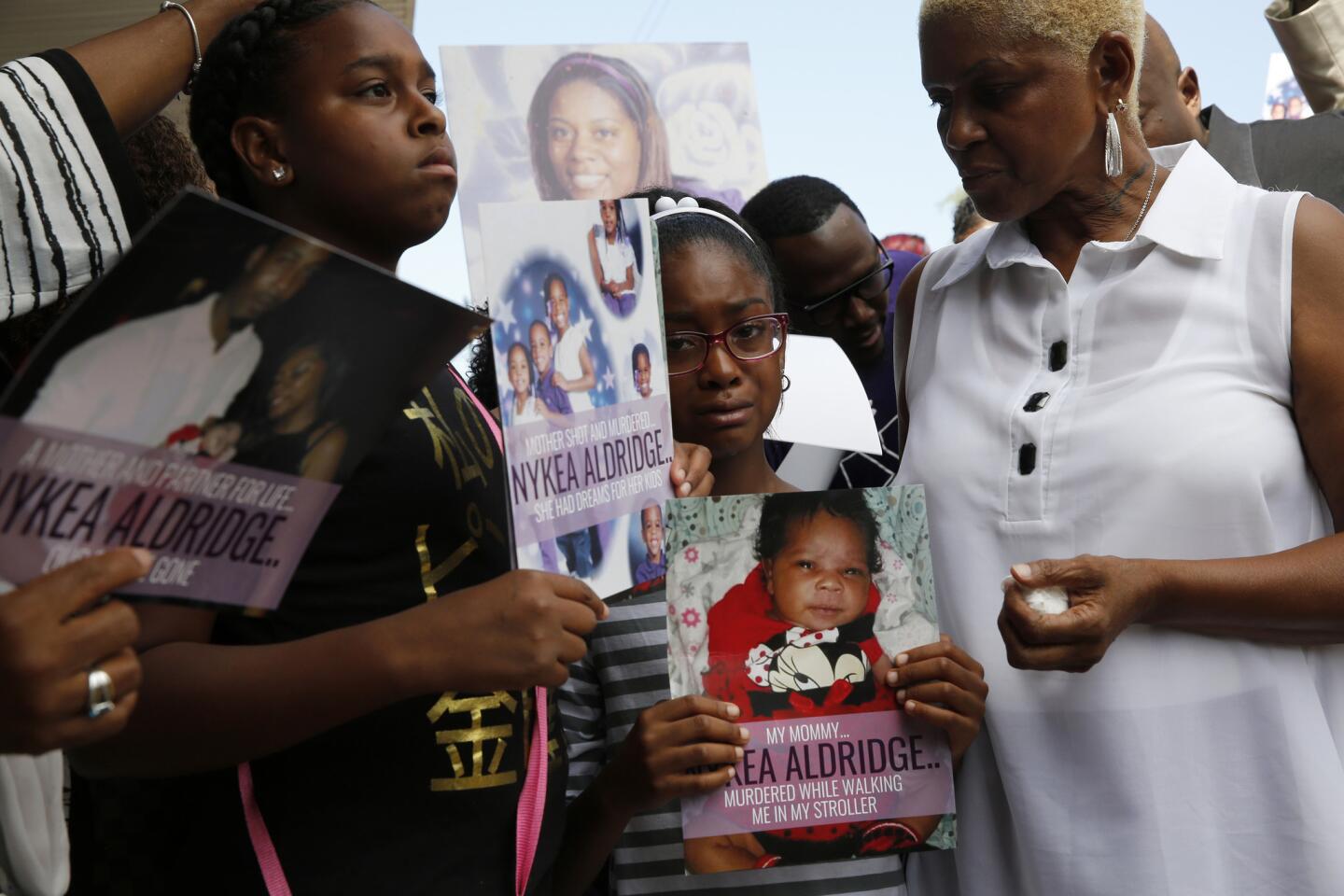 Nykea Aldridge's mother, Diann Aldridge, right, comforts two of Nykea's four children, Summer, 12, and Shavae, 8, from left, during a vigil on Aug. 28, 2016, at New Creation Church in Chicago.