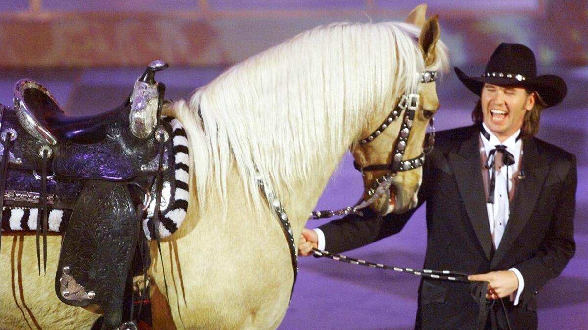 Val Kilmer walks out with a horse. Not the first time, not the last.
