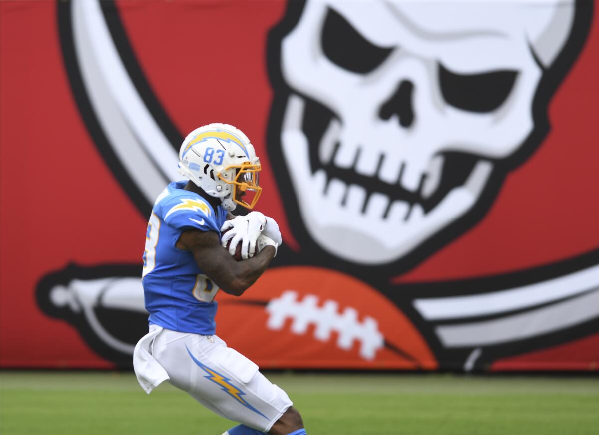 Chargers wide receiver Tyron Johnson (83) cradles the football during his 53-yard touchdown reception against Tampa Bay.