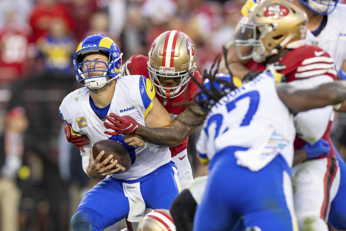 San Francisco's Deommodore Lenoir  sacks Rams quarterback Matthew Stafford.