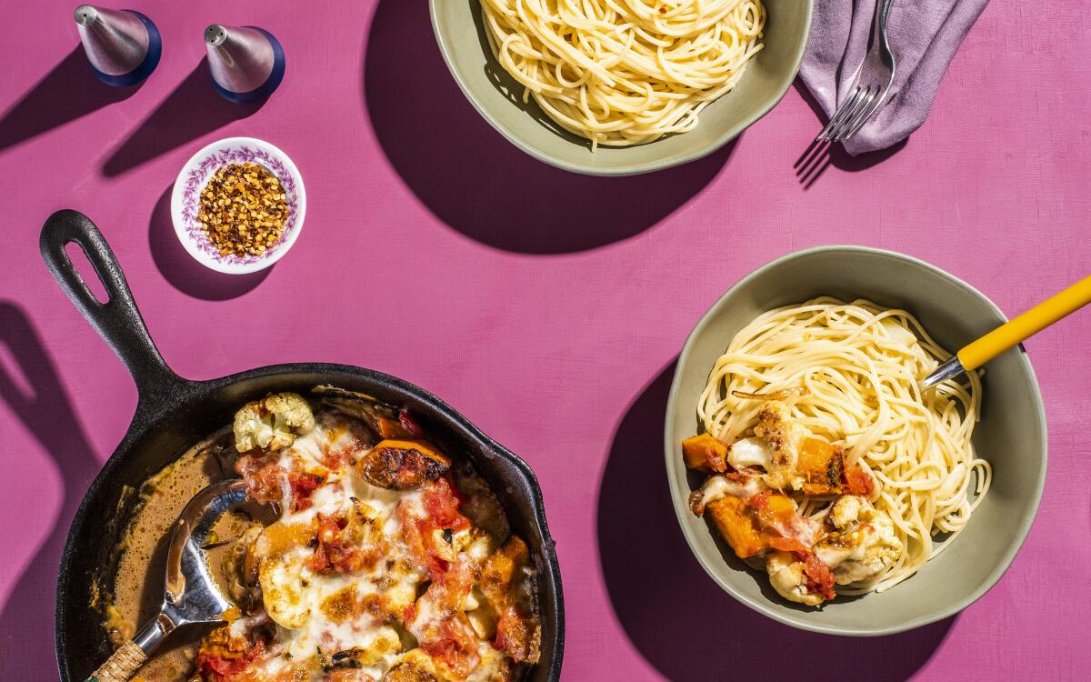 Tomatoes and mozzarella blanket roasted vegetables in this simple baked dish, perfect with a side of garlicky, spicy pasta.