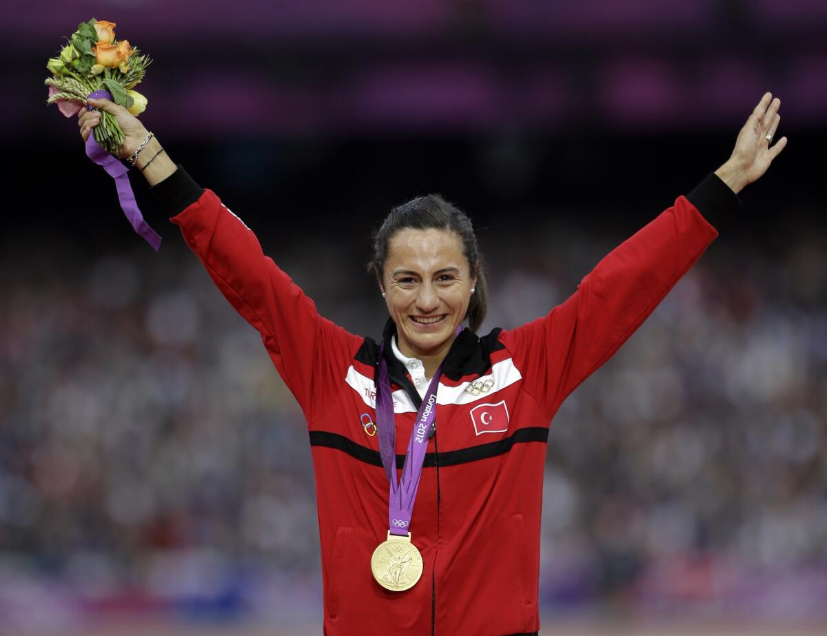 Turkey's Asli Cakir-Alptekin poses with her gold medal for the women's 1500-meter during the 2012 Summer Olympics in London.