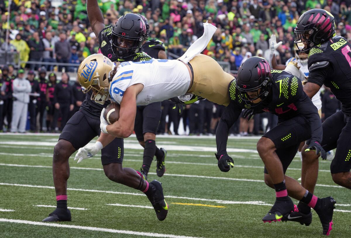 UCLA's Jake Bobo dives into the end zone for a touchdown against Oregon.