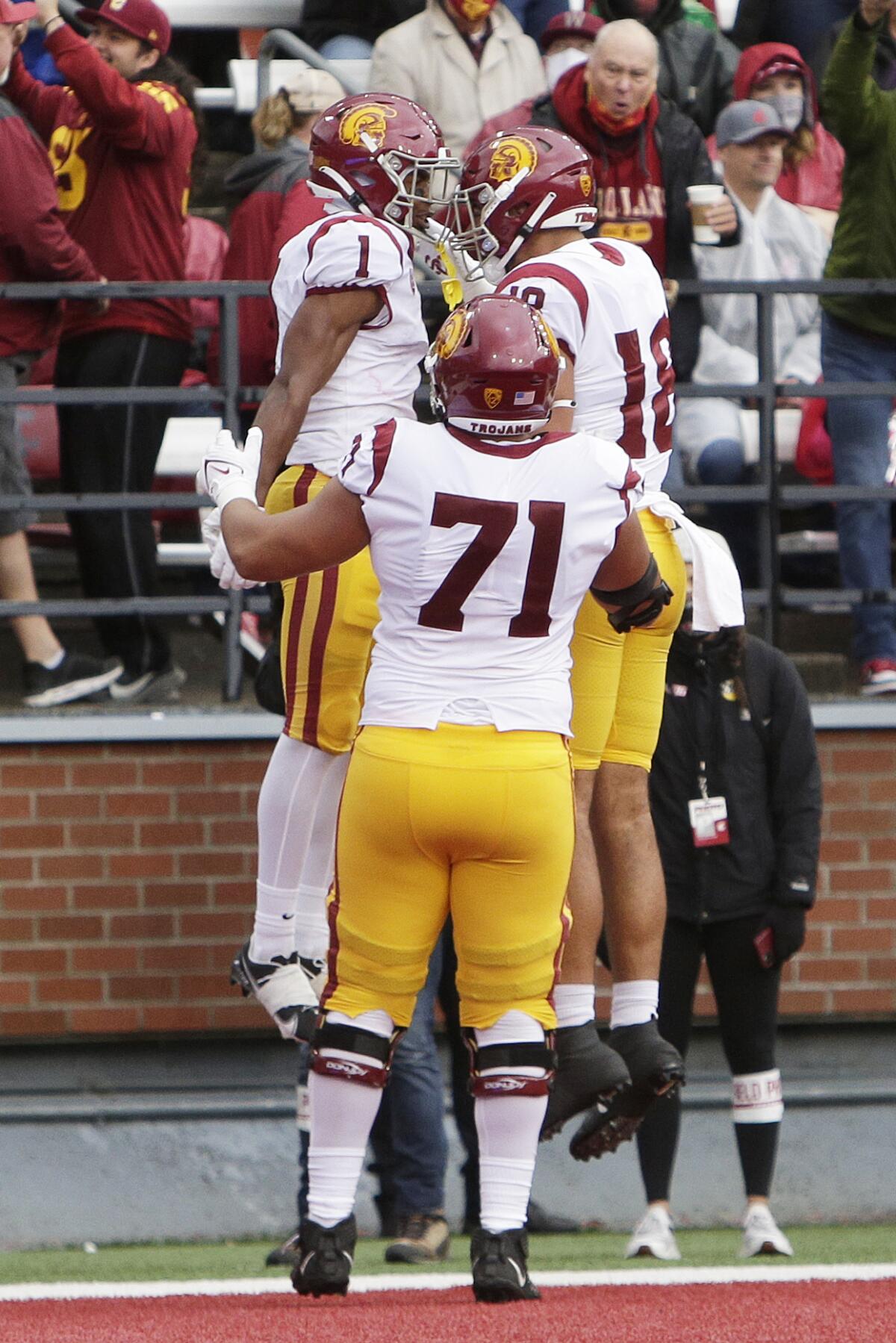 USC receiver Gary Bryant Jr. (1) celebrates his TD catch with tight end Jude Wolfe (18) and offensive lineman Liam Jimmons.