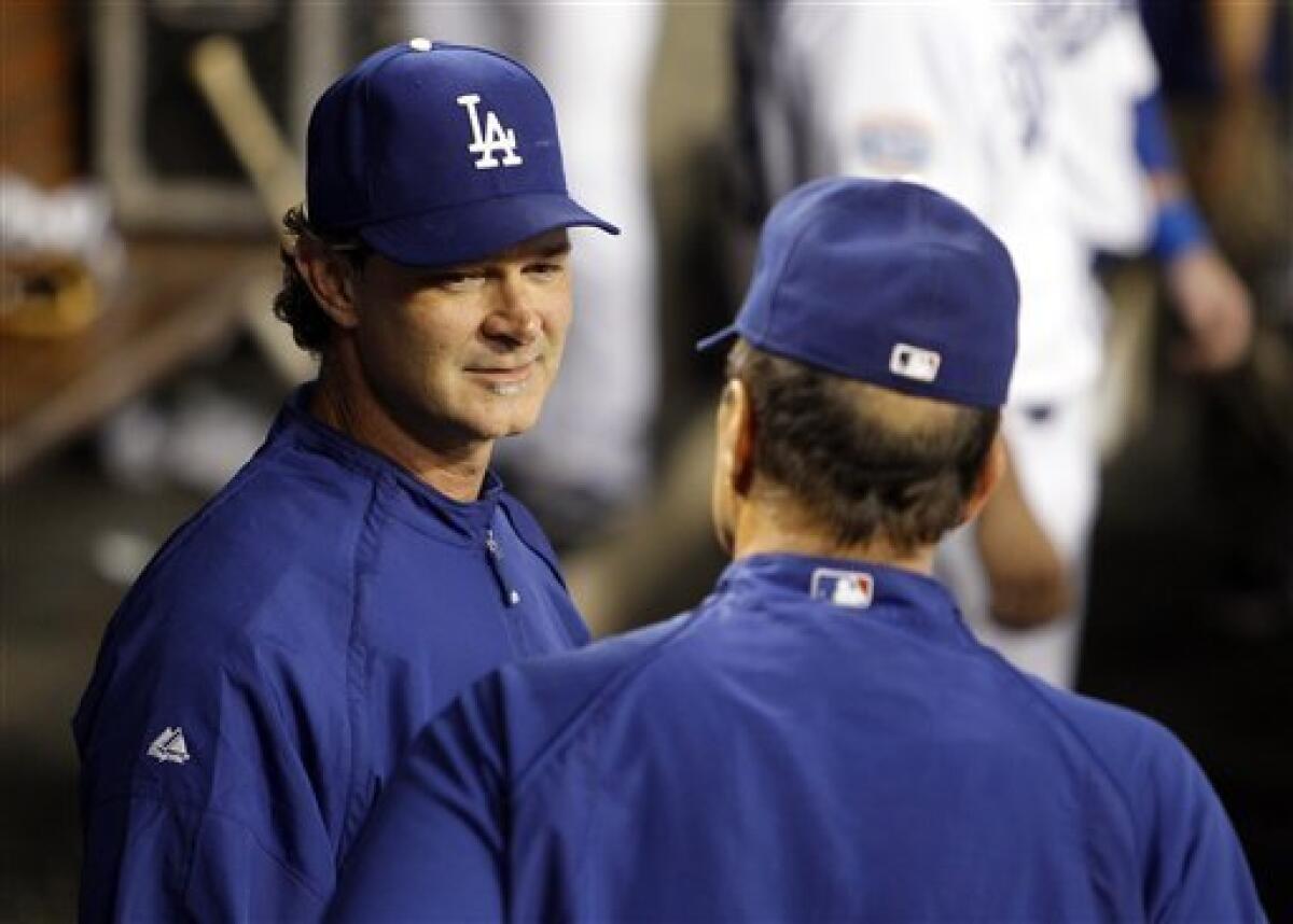 Los Angeles Dodgers manager Don Mattingly (second right) stands on