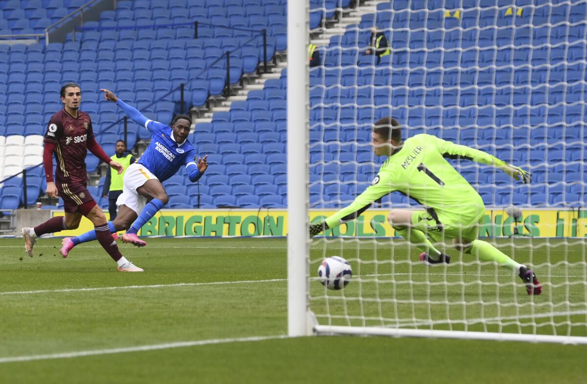 Brighton's Danny Welbeck, center, scores his side's second goal during the English Premier League soccer match between Brighton and Hove Albion and Leeds United at the Falmer stadium in Brighton, England, Saturday, May 1, 2021. (Mike Hewitt/Pool via AP)