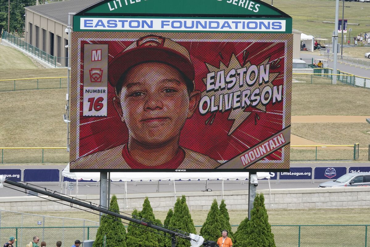 A picture of Mountain Region Champion Little League team member Easton Oliverson, from Santa Clara, Utah, is shown on the scoreboard at Volunteer Stadium during the opening ceremony of the 2022 Little League World Series baseball tournament in South Williamsport, Pa., Wednesday, Aug 17, 2022. Oliverson was injured when he fell out of a bunk bed at the dormitory complex. (AP Photo/Gene J. Puskar)