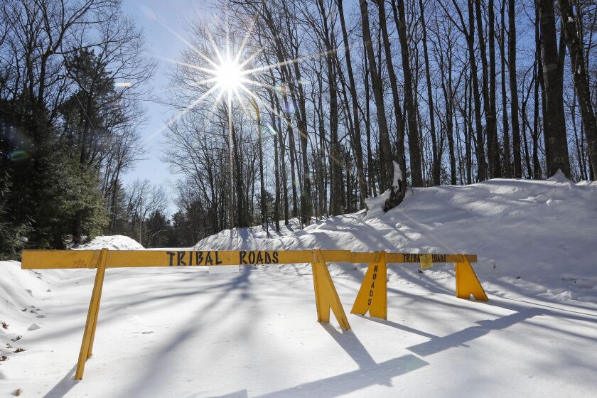FILE - A roadblock is seen along Center Sugarbush Lane on Feb. 8, 2023, along Elsie Lake Lane in Lac du Flambeau, Wis. The U.S. Department of Justice has filed a lawsuit, Wednesday, May 31, 2023, to force a northern Wisconsin town to pay unspecified damages for failing to renew access easements on American Indian tribal land. (Tork Mason/The Post-Crescent via AP, File)