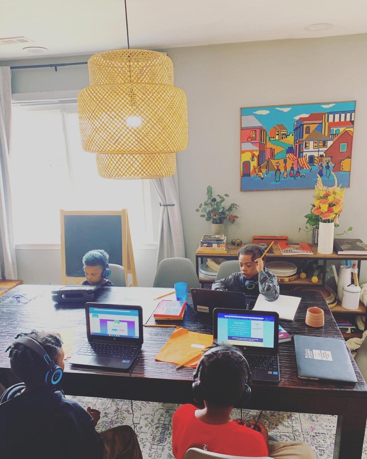 The children of Lydia Osborne work in their home classroom in Virginia Beach, Va.