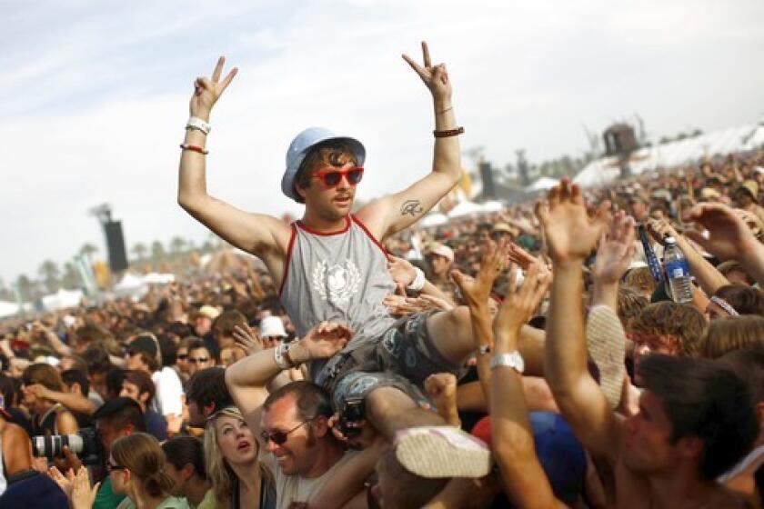 A concert-goer "crowd surfs" during the Coachella Music and Arts Festival in April 2008. This year, because of the struggling economy, festival organizers allowed people to buy three-day tickets, which cost $269, on a layaway plan.