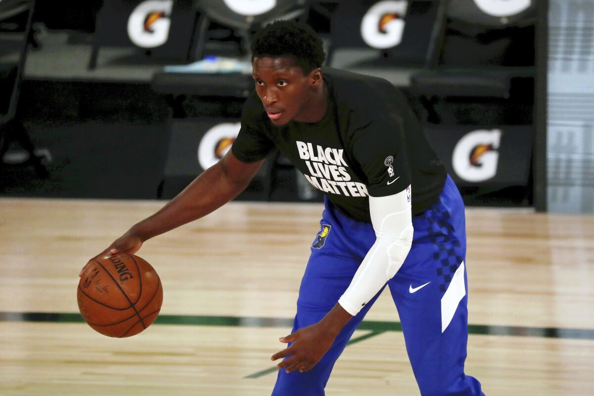FILE - In this Aug. 10, 2020, file photo, Indiana Pacers guard Victor Oladipo warms up for an NBA basketball game against the Miami Heat in Lake Buena Vista, Fla. While Oladipo’s future with the Pacers remains murky, his investments become clearer every day. Oladipo and business manager Jay Henderson have joined a group that includes former Florida basketball player Matt Walsh to purchase the New Zealand Breakers of the Australian National Basketball League. (Kim Klement/Pool Photo via AP, File)