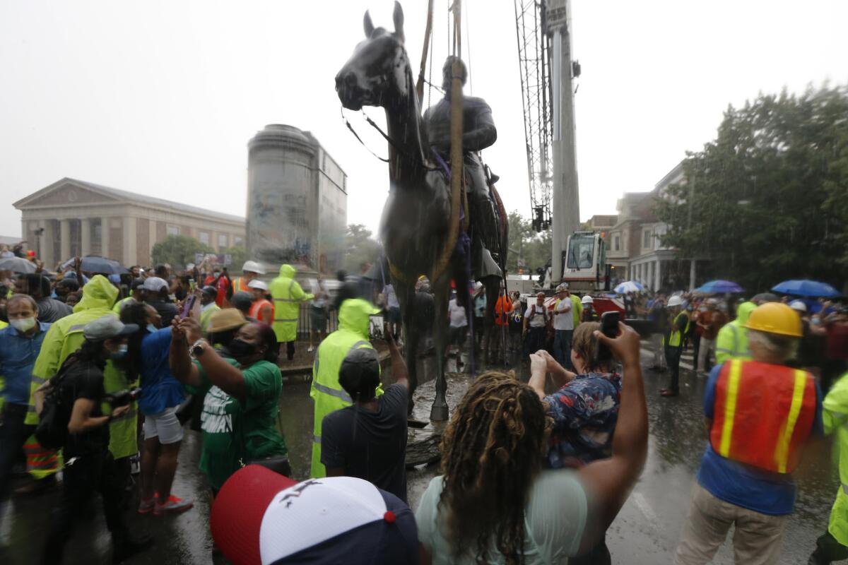 Protesters cheer as workers remove the statue of Confederate Gen. Stonewall Jackson Wednesday in Richmond, Va.