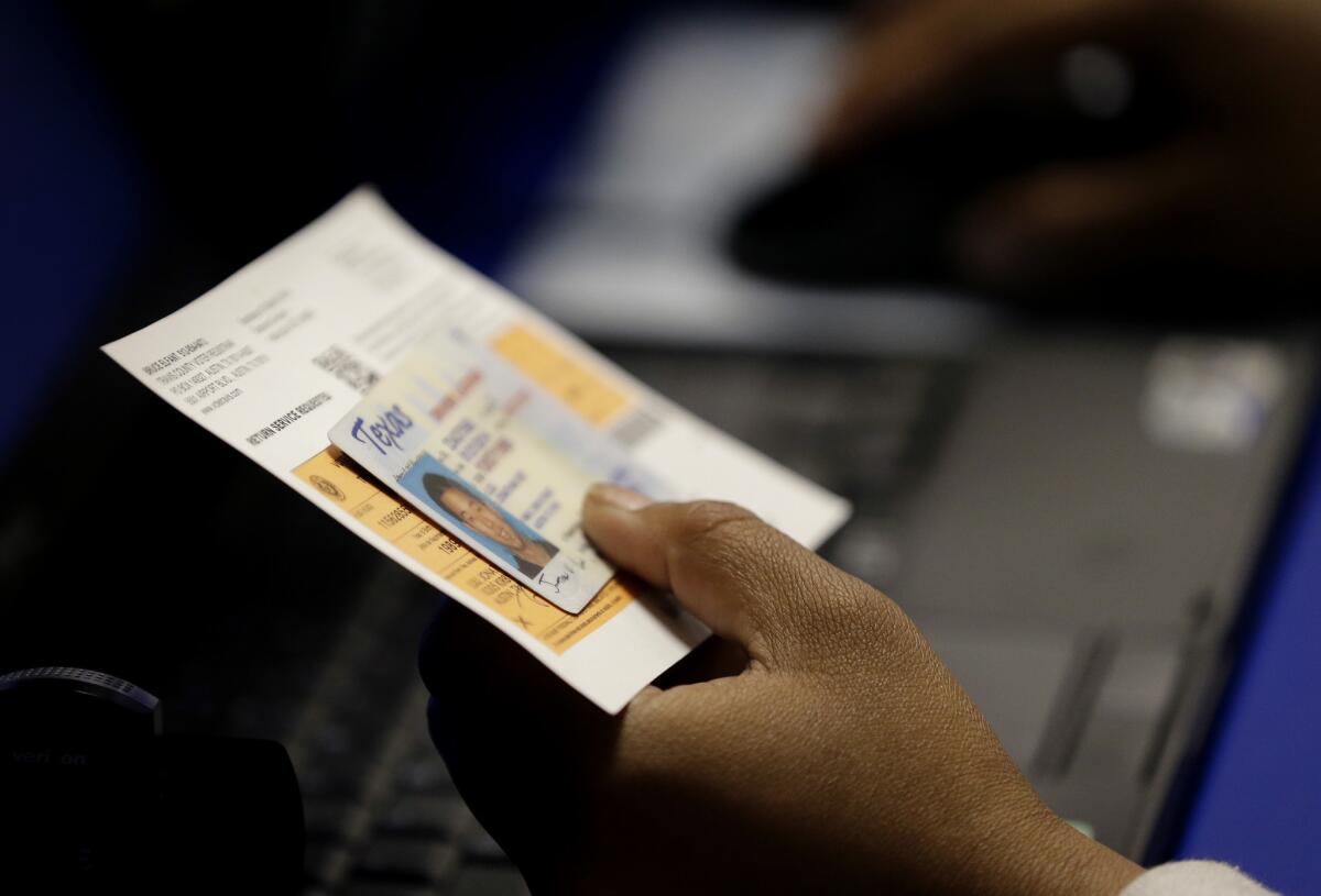 A federal judge has ruled that Texas' voter identification law was intended to discriminate against minorities and violated the Constitution and the 1965 Voting Rights Act.