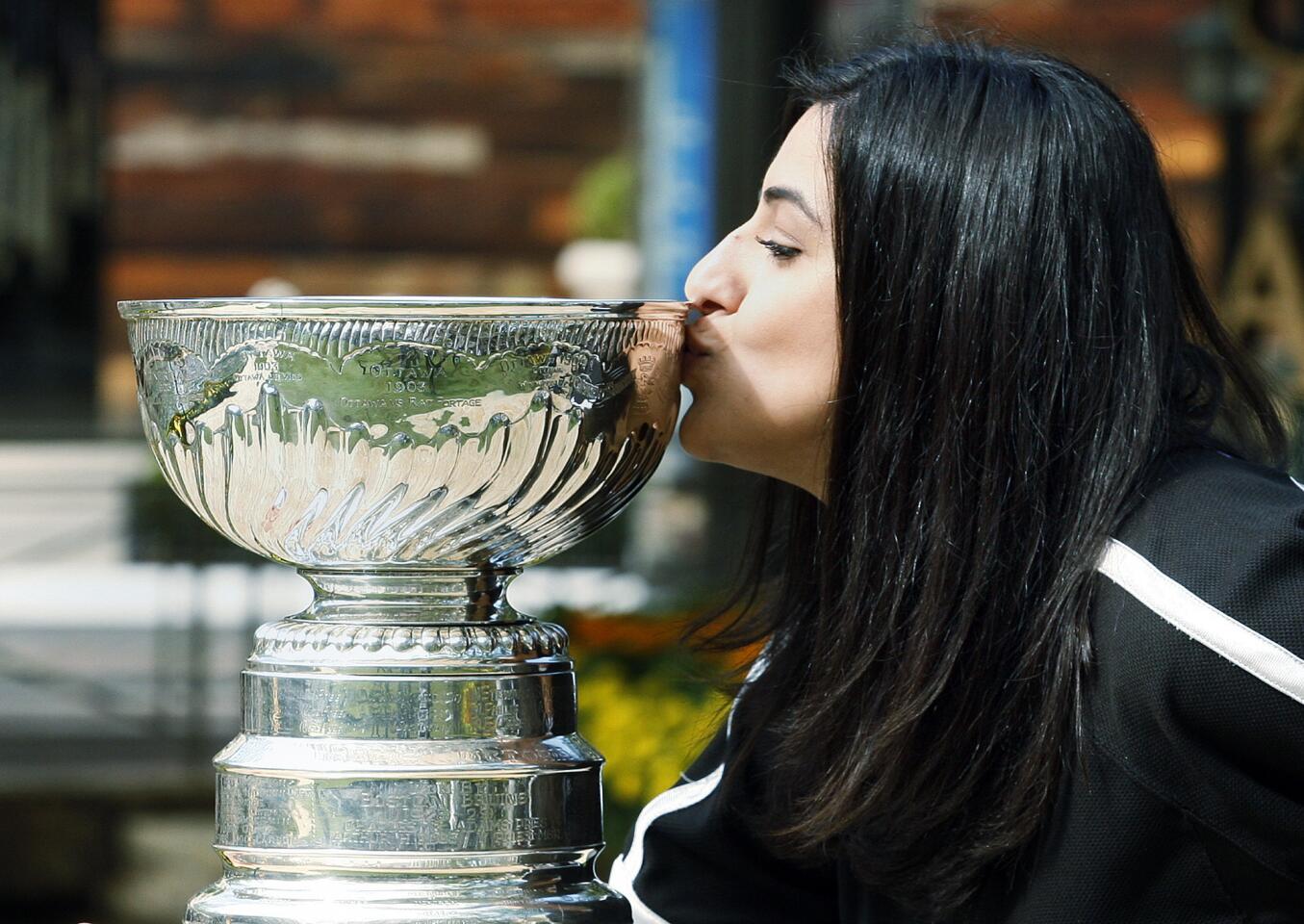 Nare Isayan, of Glendale, as she's being photographed, kisses the Stanley Cup at the Americana at Brand where the Stanley Cup was brought for Los Angeles Kings fans to experience on Friday, October 12, 2012,