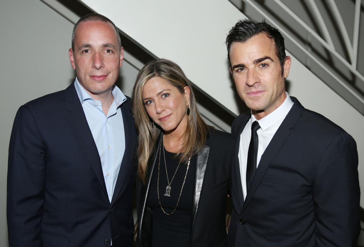 Details editor Dan Peres, left, Jennifer Aniston and Justin Theroux at the party celebrating Theroux's magazine cover.