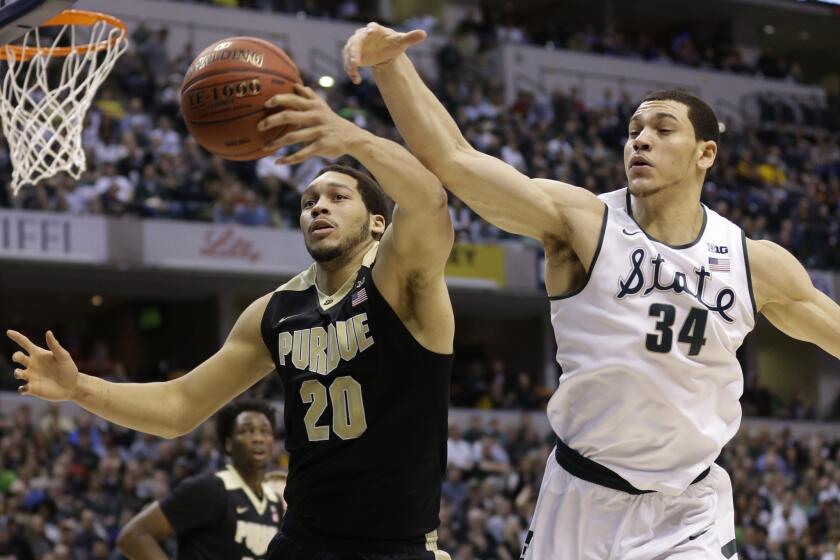 Purdue forward A.J. Hammons and Michigan State forward Gavin Schilling battle for a rebound during the first half of the Big Ten Conference championship game on March 13.