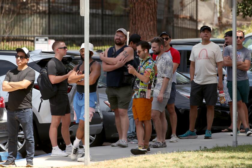 LOS ANGELES, CALIF. - JULY 21, 2022. People line up get vaccinated against the monkeypox virus on Thursday, July 21, 2022, at Eugene Obregon Park in Boyle Heights. (Luis Sinco / Los Angeles Times)