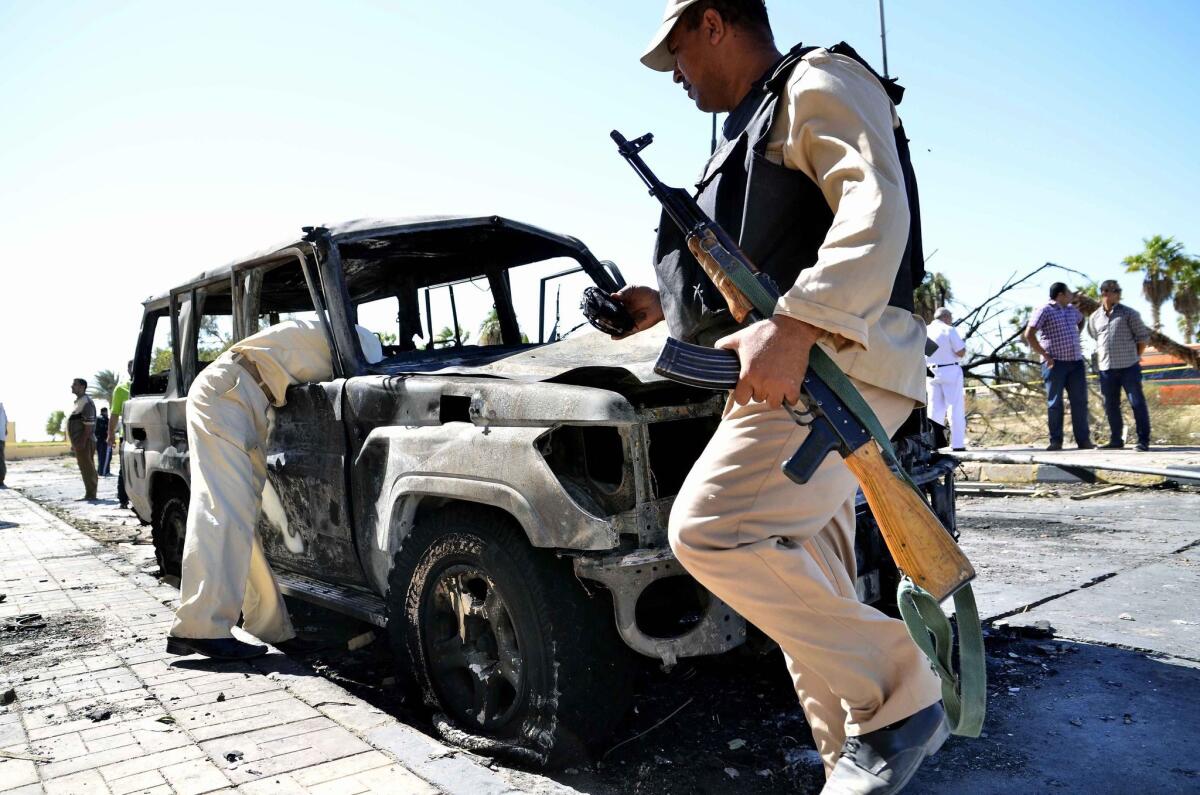 Egyptian soldiers inspect a vehicle at the site of a bombing in South Sinai on Oct. 7, 2013.