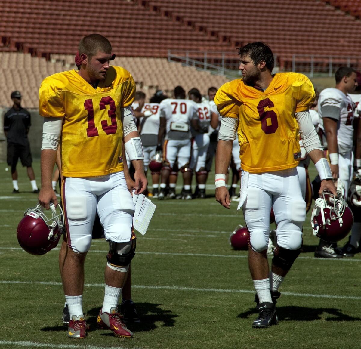 USC quarterbacks Max Wittek, left, and Cody Kessler walk off the field following Friday's practice at the Coliseum. Kessler performed well in the session.