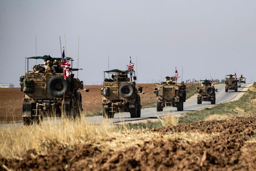 A convoy of US armoured vehicles patrols the northeastern town of Qahtaniyah at the border with Turkey, on October 31, 2019. - US forces accompanied by Kurdish fighters of the Syrian Democratic Forces (SDF) patrolled part of Syria's border with Turkey, in the first such move since Washington withdrew troops from the area earlier this month, an AFP correspondent reported. (Photo by Delil SOULEIMAN / AFP) (Photo by DELIL SOULEIMAN/AFP via Getty Images)
