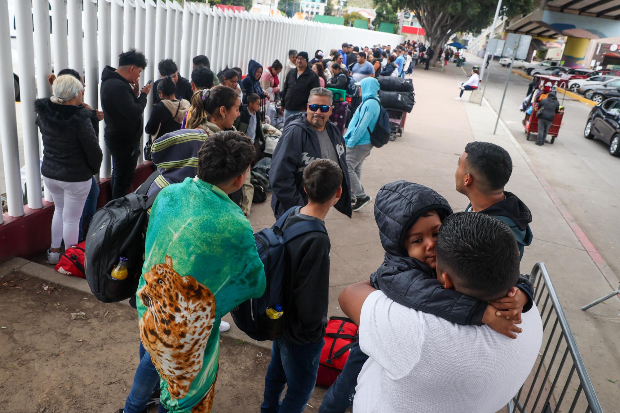 Hundreds of asylum seekers who used a CBP phone app to make an appointment, wait to for a 